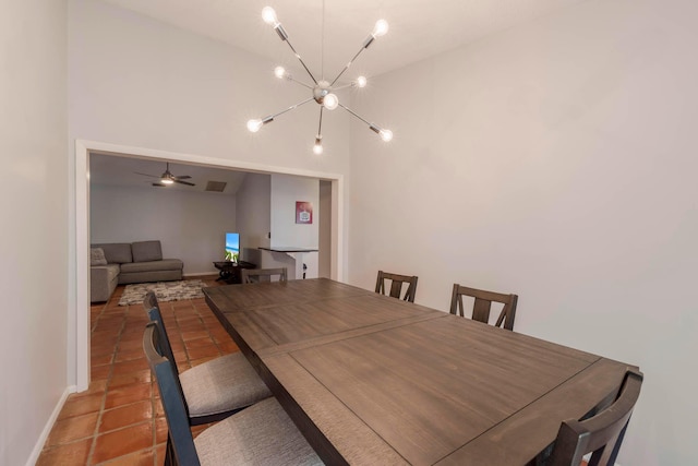 dining space with ceiling fan with notable chandelier and light tile floors