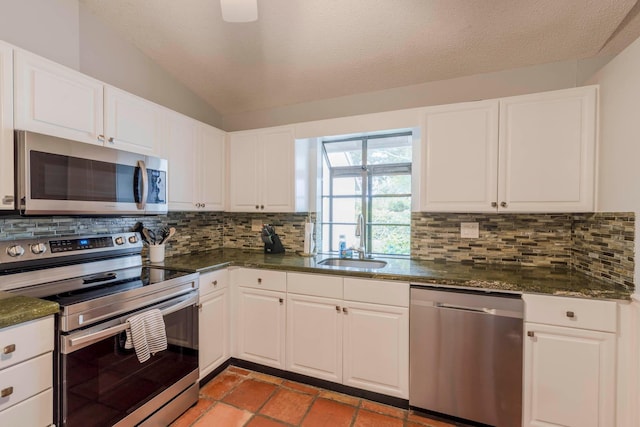 kitchen featuring backsplash, appliances with stainless steel finishes, light tile floors, and sink