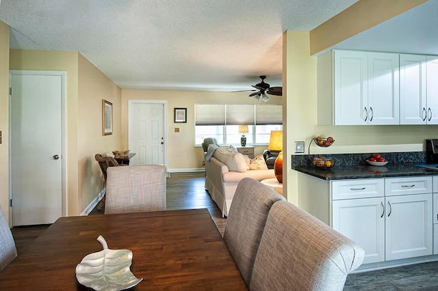 dining area featuring a textured ceiling, dark hardwood / wood-style floors, and ceiling fan