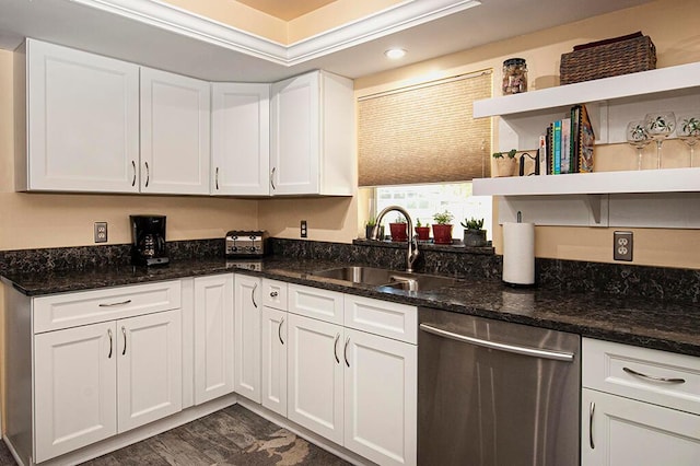 kitchen featuring dark stone counters, white cabinets, sink, and dishwasher