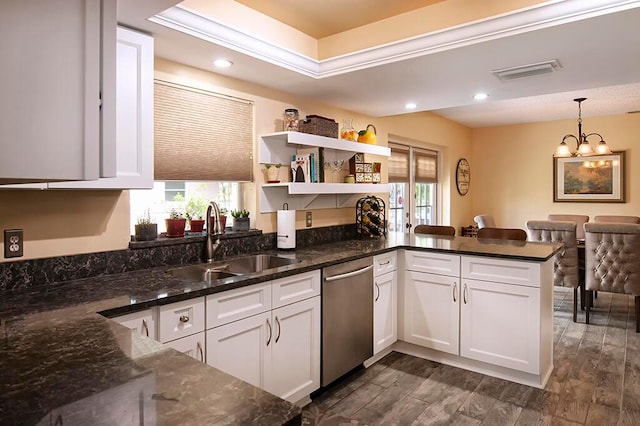 kitchen featuring sink, hanging light fixtures, white cabinets, dishwasher, and dark wood-type flooring