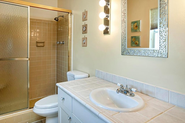 bathroom with a shower with shower door, oversized vanity, and toilet