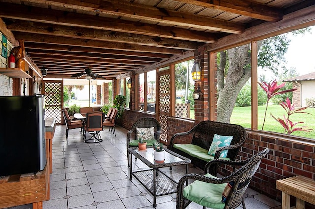 sunroom / solarium with ceiling fan and beam ceiling