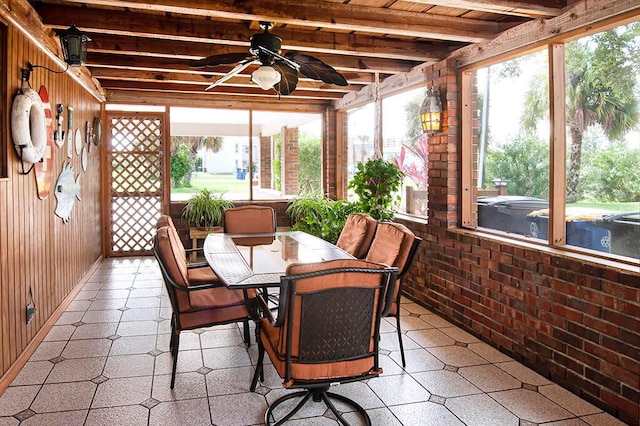 sunroom with beam ceiling, a healthy amount of sunlight, and ceiling fan