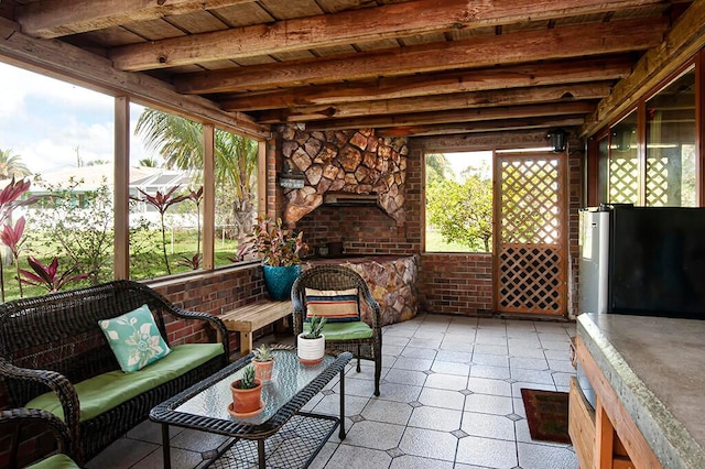 sunroom featuring beam ceiling