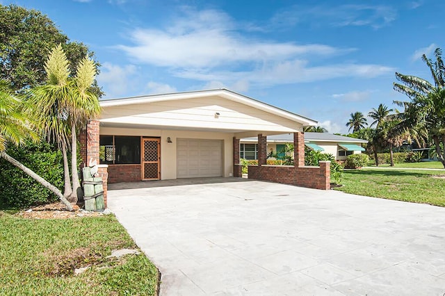 view of front of property featuring a carport, a front yard, and a garage