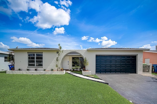 single story home with a front yard and a garage