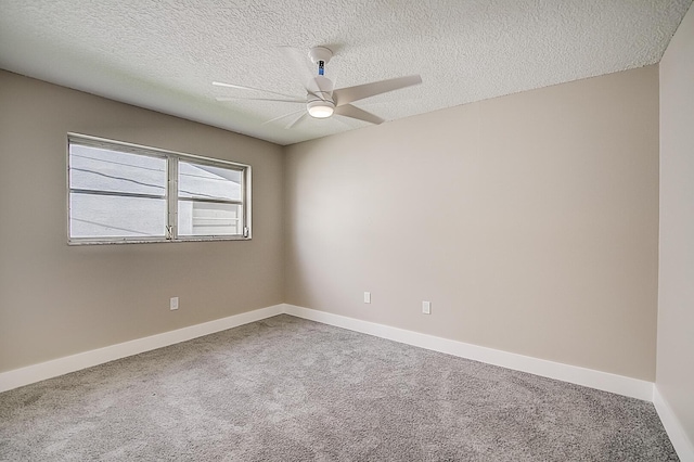 unfurnished room featuring a textured ceiling, ceiling fan, and carpet