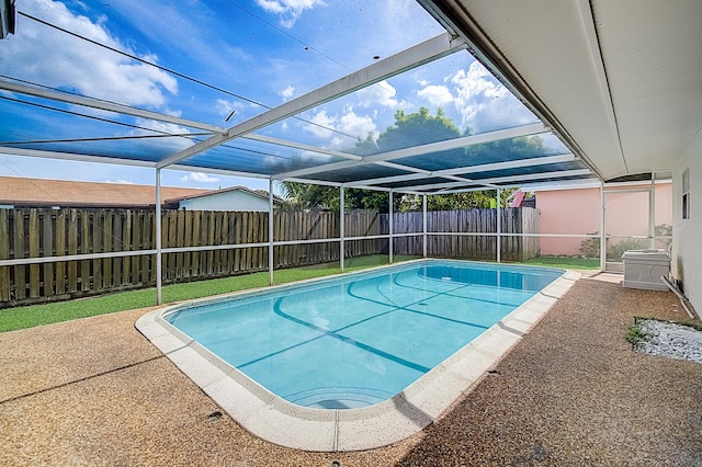 view of swimming pool featuring a lanai and a patio