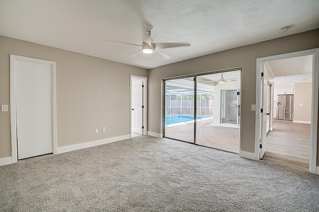 interior space with access to outside, stainless steel refrigerator with ice dispenser, and light colored carpet