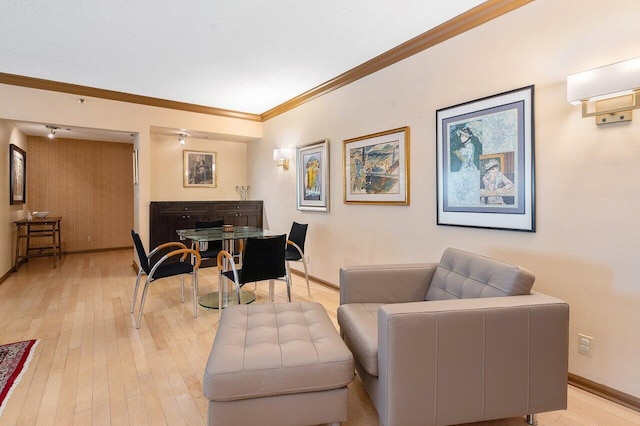 living room featuring ornamental molding and light wood-type flooring