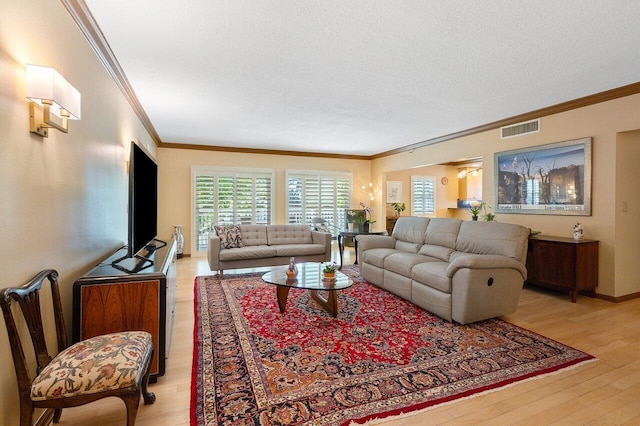 living room featuring a textured ceiling, hardwood / wood-style flooring, and ornamental molding