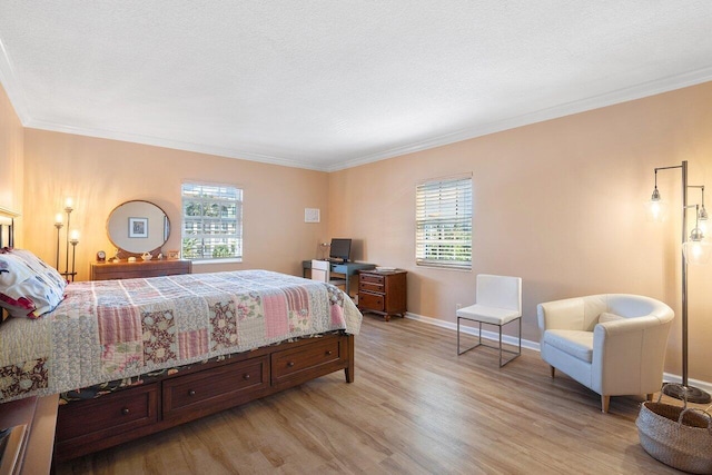 bedroom featuring ornamental molding, wood-type flooring, and a textured ceiling