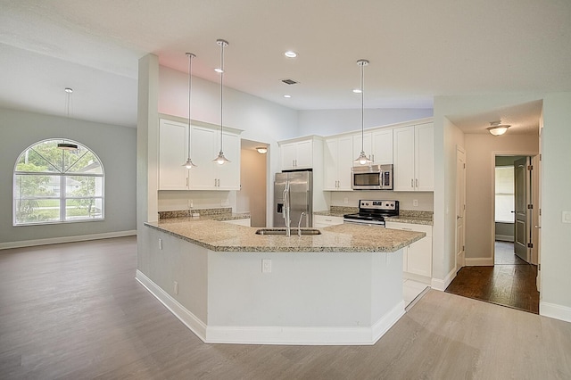 kitchen with dark hardwood / wood-style floors, hanging light fixtures, and appliances with stainless steel finishes