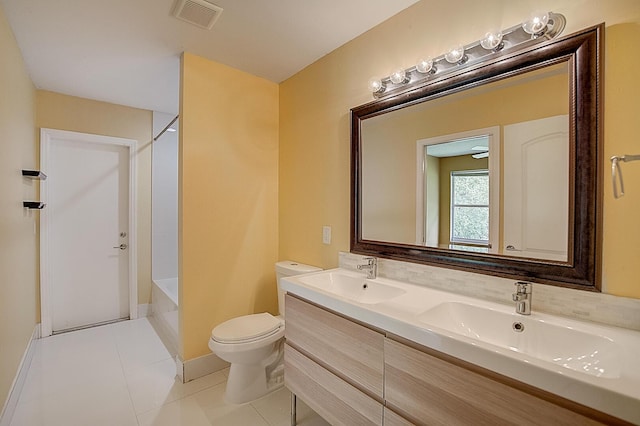 full bathroom featuring dual sinks, tile flooring, washtub / shower combination, toilet, and large vanity