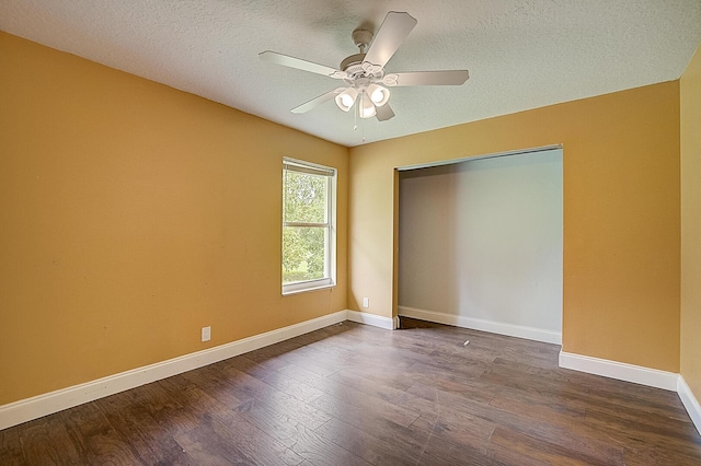 interior space with dark wood-type flooring, ceiling fan, and a textured ceiling