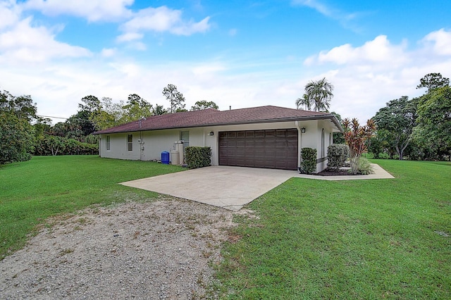 single story home with a front yard and a garage