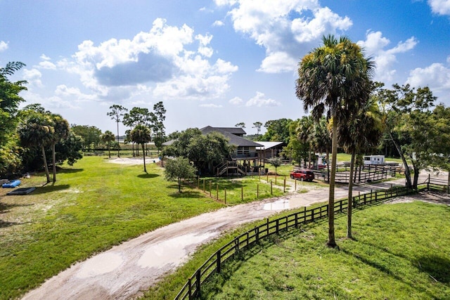 view of property's community featuring a rural view and a yard