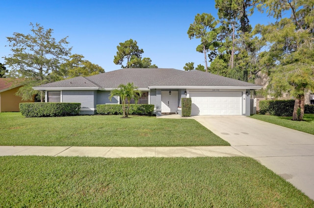 ranch-style home featuring a front lawn and a garage