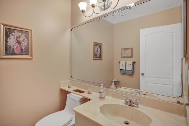 bathroom featuring toilet and vanity