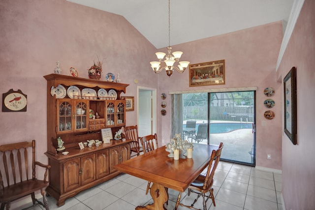 dining area with high vaulted ceiling, an inviting chandelier, and light tile flooring