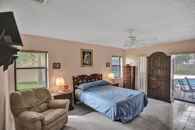 tiled bedroom featuring access to exterior, ceiling fan, and a textured ceiling