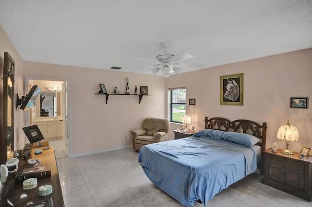 tiled bedroom with a textured ceiling, ceiling fan, and ensuite bathroom