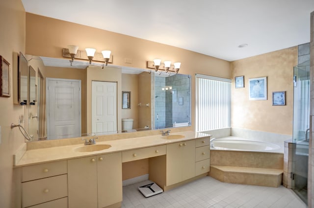 bathroom with a relaxing tiled bath, tile floors, double vanity, and toilet