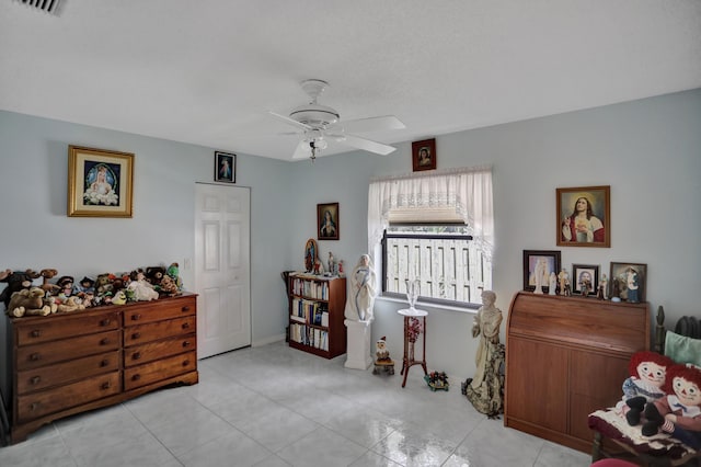 misc room featuring ceiling fan and light tile floors