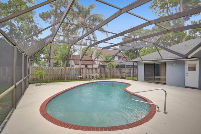 view of swimming pool featuring a patio area and a lanai