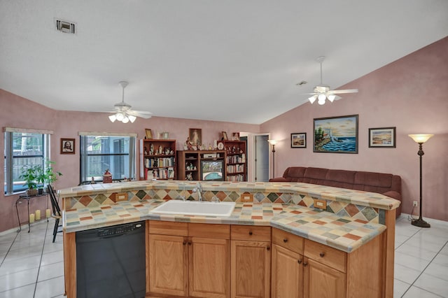 kitchen featuring vaulted ceiling, black dishwasher, ceiling fan, and sink