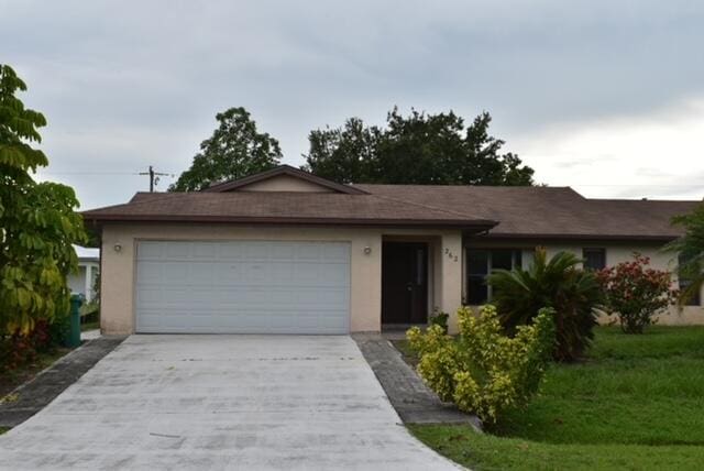 single story home featuring a garage