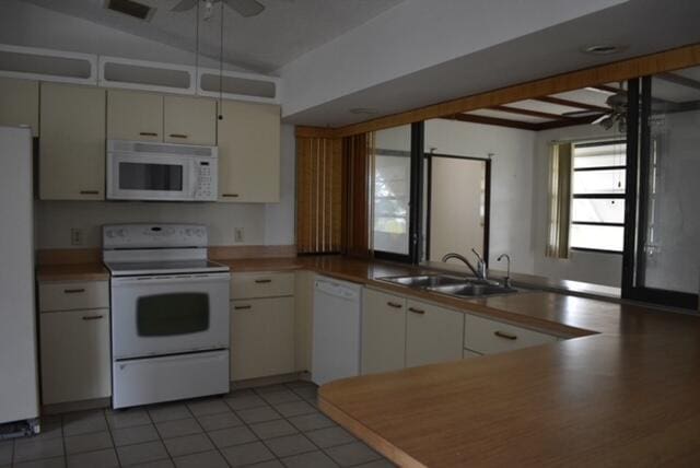 kitchen with light tile floors, ceiling fan, white appliances, white cabinetry, and sink