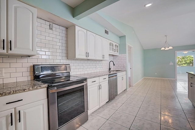 kitchen with light stone counters, appliances with stainless steel finishes, backsplash, white cabinetry, and vaulted ceiling with beams