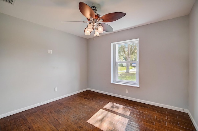 spare room with ceiling fan and dark hardwood / wood-style flooring
