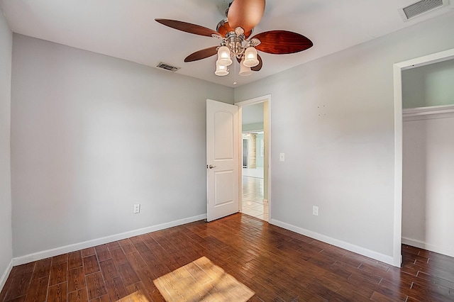 unfurnished bedroom with a closet, dark hardwood / wood-style floors, and ceiling fan