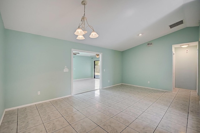 tiled spare room featuring vaulted ceiling and ceiling fan with notable chandelier