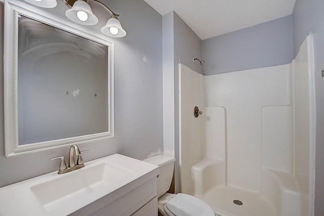 bathroom with a shower, toilet, and vanity