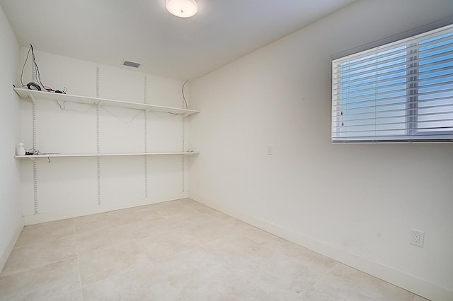 walk in closet featuring light tile flooring