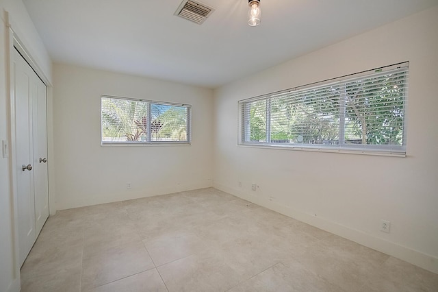 interior space with a closet and light tile floors