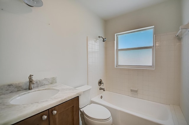 full bathroom featuring vanity, toilet, and tiled shower / bath