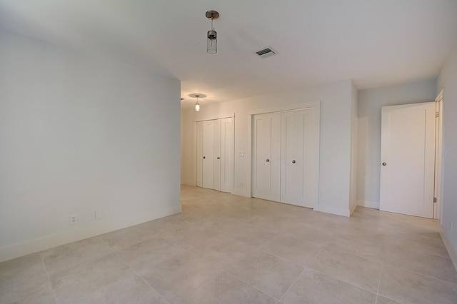 unfurnished room with light tile floors