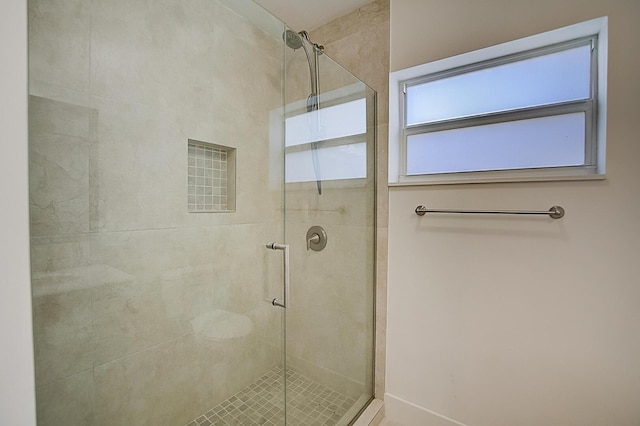 bathroom featuring a shower with door