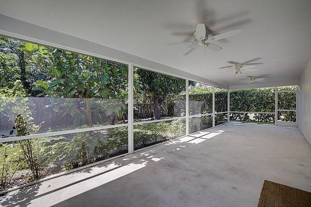 unfurnished sunroom with ceiling fan