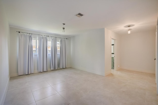 spare room featuring light tile floors