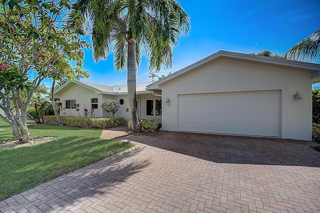 single story home with a front yard and a garage