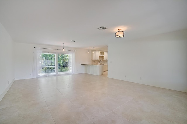 unfurnished living room with light tile floors