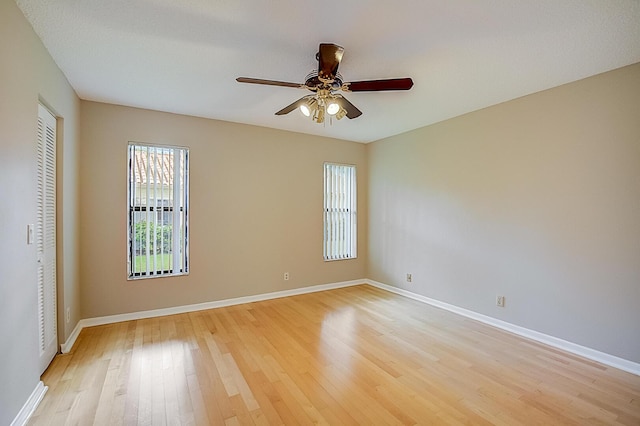 unfurnished room with ceiling fan and light wood-type flooring