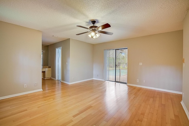 unfurnished room featuring a textured ceiling, ceiling fan, and light wood-type flooring