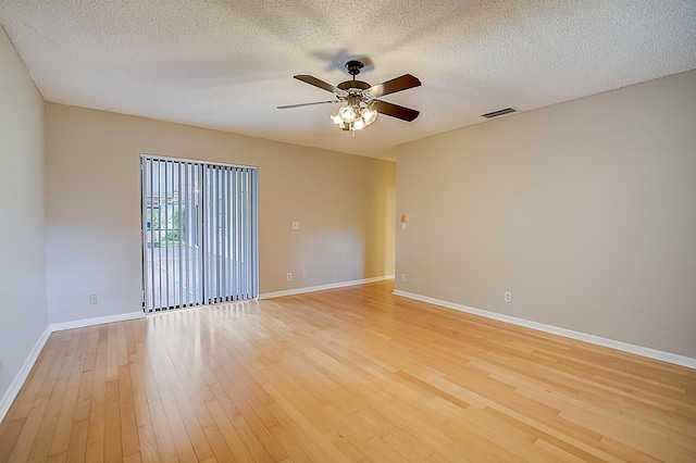 unfurnished room with a textured ceiling, ceiling fan, and light hardwood / wood-style flooring